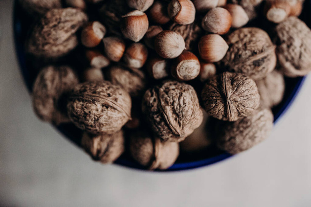 A top view of walnuts with hazelnuts on in a bowl - Zdjęcie, obraz