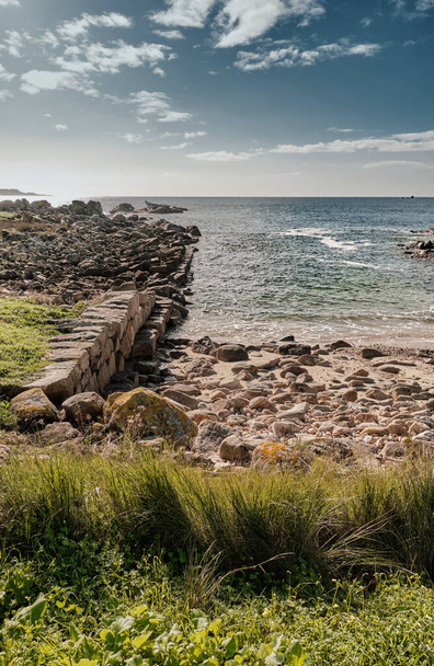 A vertical shot of coast with rocks and stones - Zdjęcie, obraz