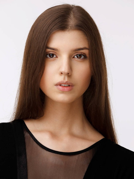 Beauty people portrait. Girl of a natural skin, wear in black dress, looking at camera, over white background. - Φωτογραφία, εικόνα