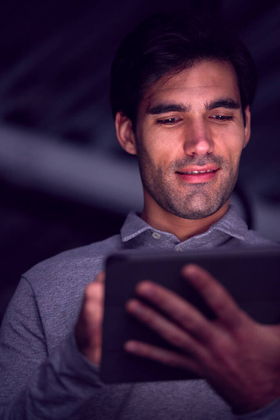 Businessman Working Late Using Digital Tablet With Face Illuminated - Фото, зображення
