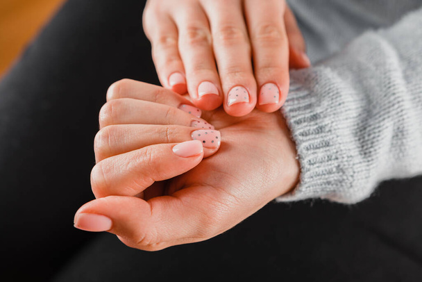Beautiful woman's hands with pink nails on the white background. Nail varnishing in pink color. Manicure, pedicure beauty salon concept. - Fotoğraf, Görsel