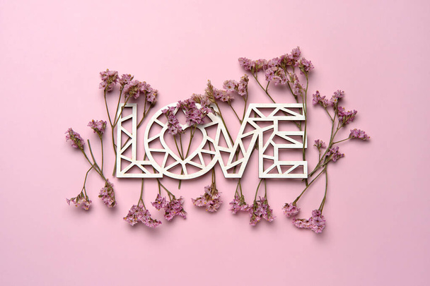Creative flat lay of word love on soft color  background with natural plants.  - Fotoğraf, Görsel