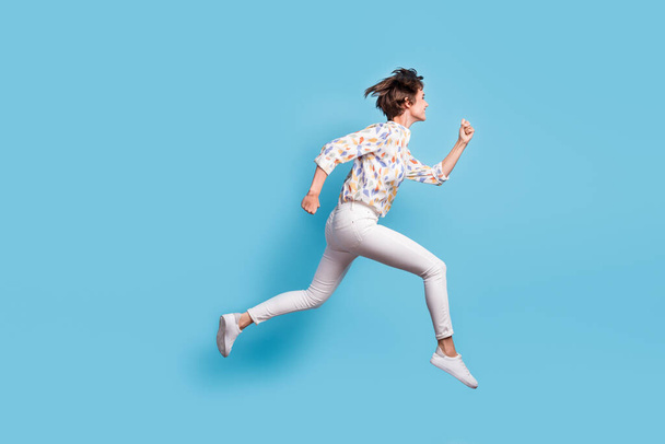 Full body profile side photo of young active girl happy hurry run jump sale look empty space isolated over blue color background - Fotografie, Obrázek