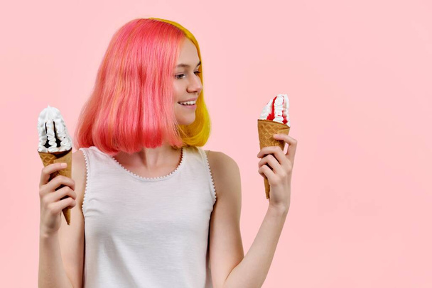 Happy with colored dyed hair model teenager holding ice cream in cones - Фото, изображение