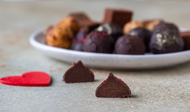 Variety of sweet homemade chocolate candies and truffles, light concrete background. Selective focus. - Φωτογραφία, εικόνα