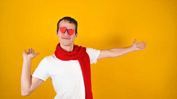 Man with a red scarf, on a yellow background. High quality photo - Valokuva, kuva