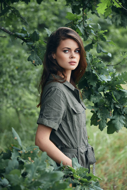 Woman in the forest Look aside hands in pockets lifestyle background  - Fotografie, Obrázek