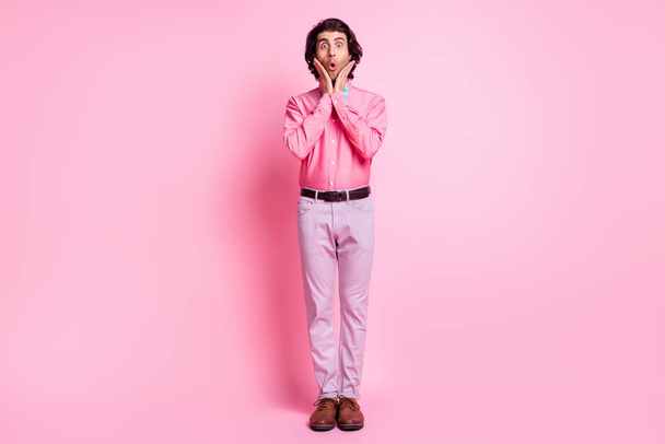 Full size photo of shocked charming young man hold hands cheekbones unexpected present isolated on pink color background - Foto, Bild