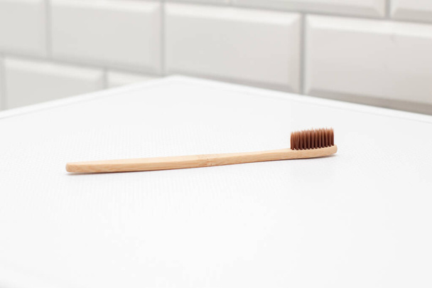 Bamboo toothbrush in the bathroom. Zero waste concept - Foto, Bild