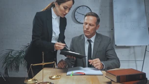 Insurance agent showing clipboard to angry colleague in office  - Footage, Video