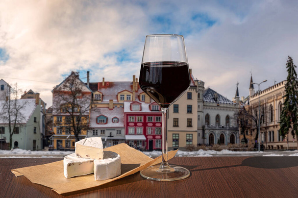Sklenice vína s tvarohem na barevných budovách v historickém centru města v Rize, Lotyšsko - Fotografie, Obrázek