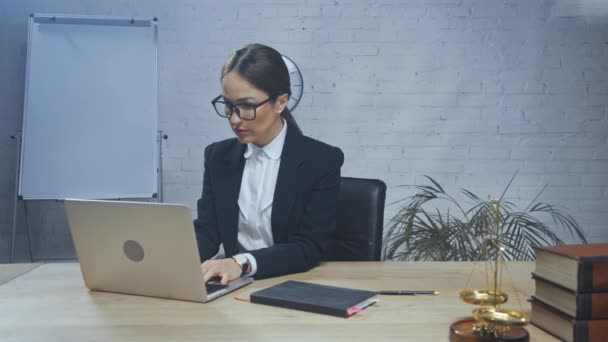 Agente assicurativo che lavora con laptop e notebook in ufficio  - Filmati, video