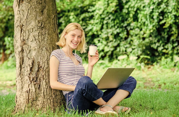 Lunch time relax or coffee break. Work in summer park. Reasons why you should take your work outside. Nature is essential to wellbeing and ability to be productive. Girl work with laptop in park - Fotoğraf, Görsel