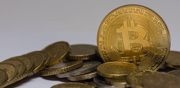golden valuable bitcoin standing between other coins detail panorama view - Photo, Image