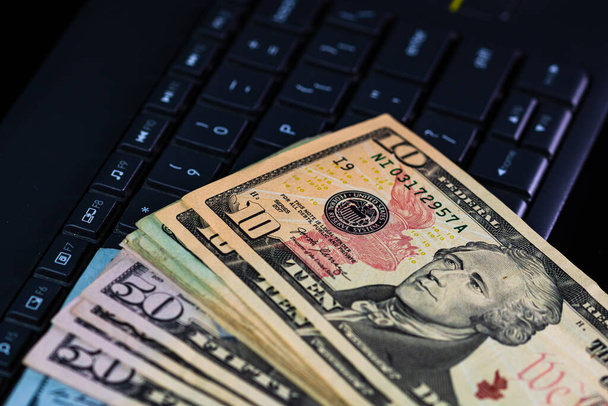 Close up of dollars money on keyboard isolated. - Photo, Image