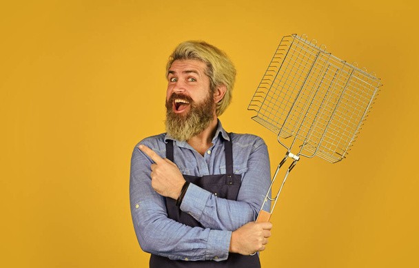 Grilled and smoked. bearded man chef. Tools for roasting meat outdoors. Picnic and barbecue. ready for barbecue party. Culinary concept. summer weekend. hipster hold cooking utensils for barbecue - 写真・画像
