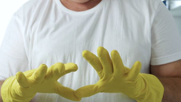 Closeup Image with a Person Hands Wearing Protective Yellow Household Gloves Used in the Kitchen Cleanse - Zdjęcie, obraz