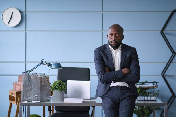 Handsome young businessman with folded arms in the office. self confident African American man with crossed hands portrait. Business, success, people, office lyfestyle concept - Photo, Image