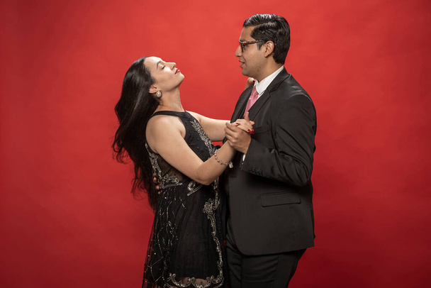 Couple in love dancing on red background. Valentine's Day. - Фото, изображение