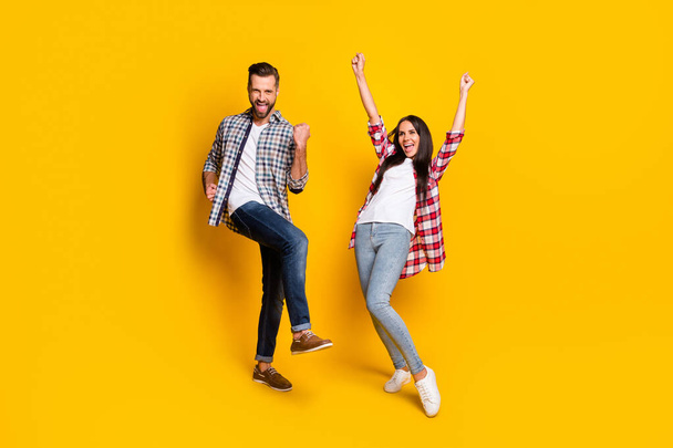 Full length photo portrait of excited crazy couple celebrating isolated on vivid yellow colored background - Foto, Bild