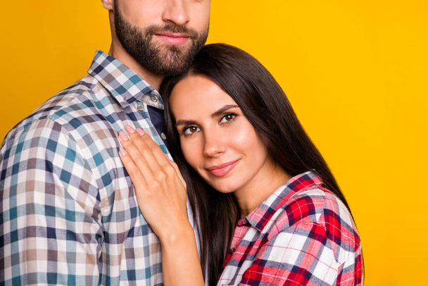 Photo portrait of woman laying on mans chest hugging isolated on vivid yellow colored background - 写真・画像
