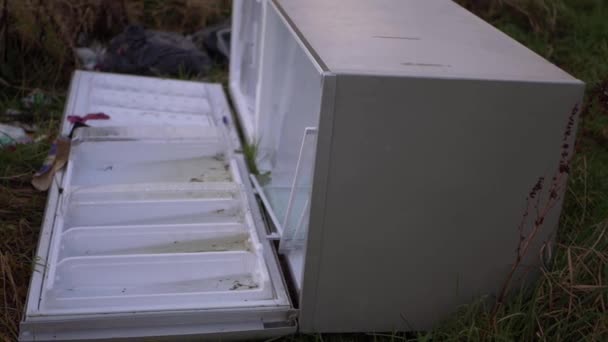 Refrigerator dumped in countryside field isolated shot - Footage, Video