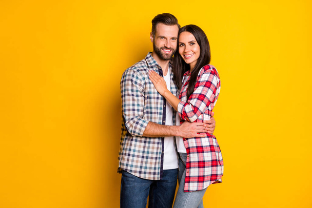 Portrait of attractive cheerful sweet couple embracing spending time isolated over bright yellow color background - Fotoğraf, Görsel
