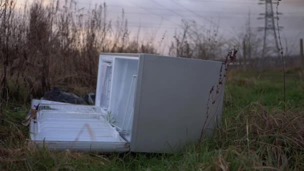 Refrigerator dumped in countryside field wide shot - Footage, Video