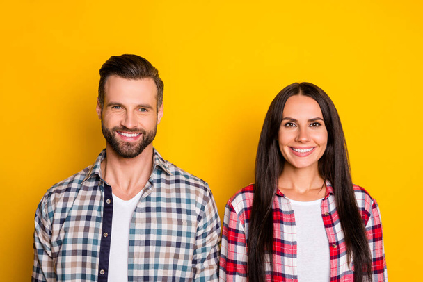 Photo portrait of smiling happy couple isolated on vivid yellow colored background - Foto, imagen