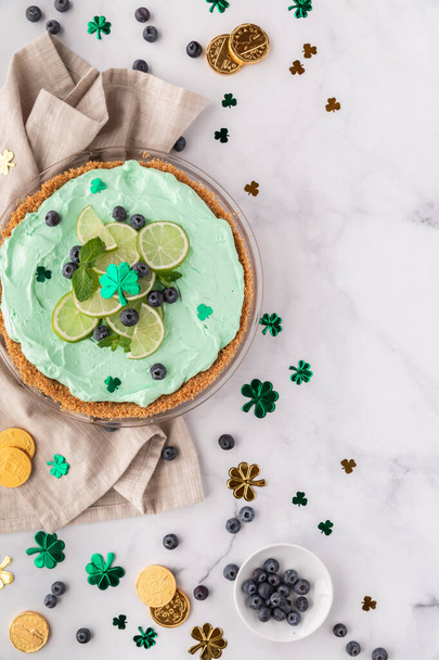 Top down view of a Key Lime Pie with St. Patricks Day decorations all around. - Photo, Image
