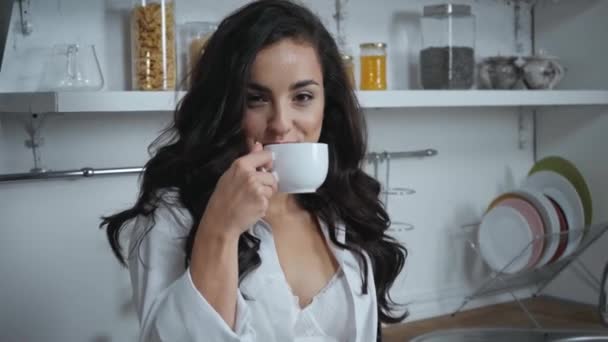 femme sensuelle en sous-vêtements et chemise boire du café dans la cuisine - Séquence, vidéo