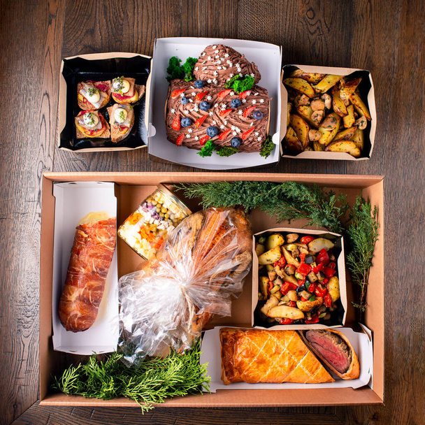 Healthy food delivery. Take away vegetables, meat in boxes. Top view, flat lay with copy space. delivery of ready-made food in boxes for festive table top view - Фото, зображення
