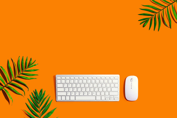 Computer keyboard and mouse with tropical plants - Foto, Bild