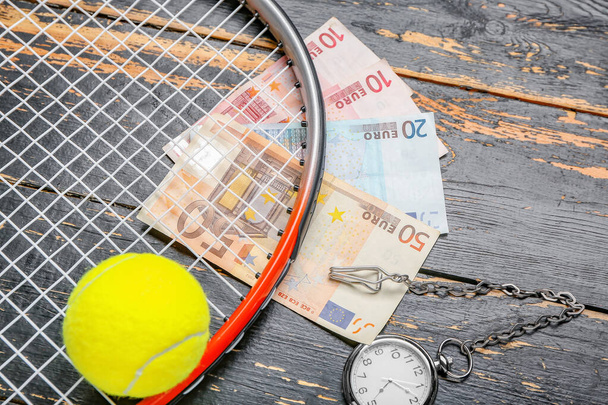 Money, tennis rocket and clock on wooden background - Zdjęcie, obraz
