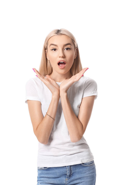 Surprised young woman on white background - 写真・画像