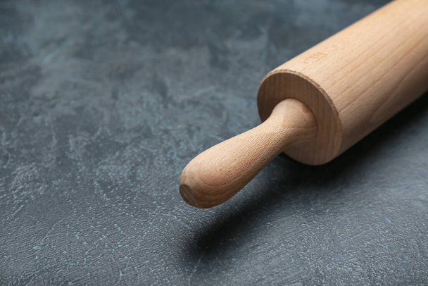 Wooden rolling pin on dark background - Fotó, kép