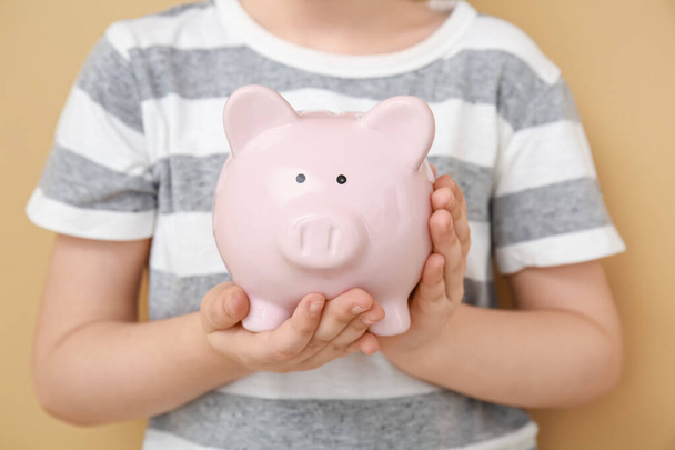 Child holding piggy bank. Money savings concept - Фото, изображение