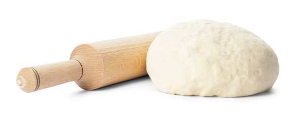 Fresh dough and rolling pin on white background - Photo, Image