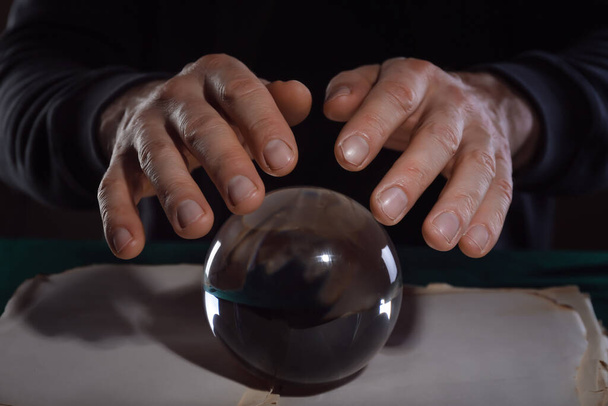 Fortune teller with crystal ball and book at table - Photo, Image