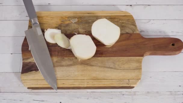 Mincing organic yellow onion on a wood cutting board. - Footage, Video