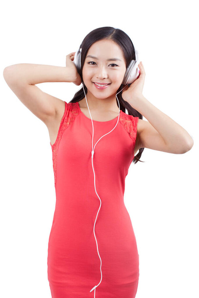 Young woman listening to music with headphones - Fotoğraf, Görsel