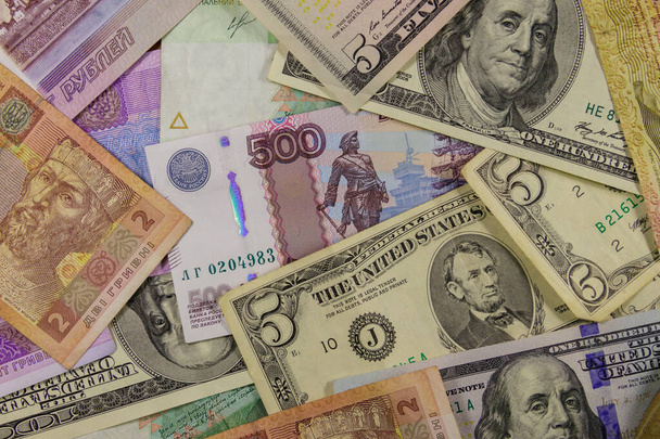 Мультивалютный фон американских долларов, российских рублей и украинских гривен - Фото, изображение