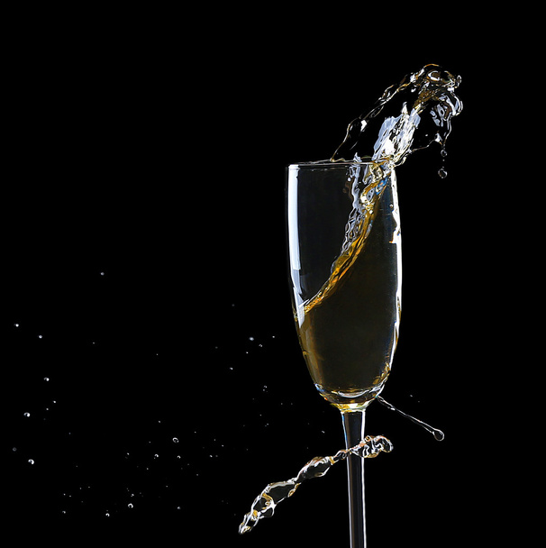 Glass of champagne with splash, on black background - Zdjęcie, obraz