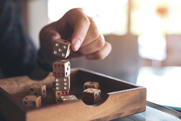 Closeup image of hand playing and building wooden dices  - Фото, зображення