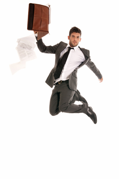 Young businessman jumping with open briefcase falling papers copy-space iso - Photo, Image