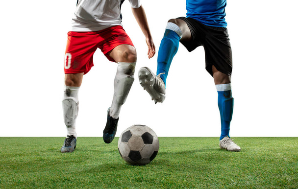 Close up legs of professional soccer, football players fighting for ball on field isolated on white background - Photo, image