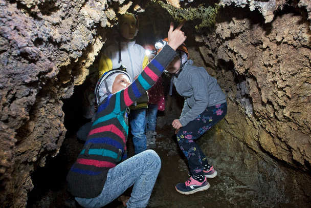 παιδιά εξετάζουν σχέδια αρχαίων ανθρώπων σε μια σπηλιά της Τενερίφη στην Τενερίφη - Φωτογραφία, εικόνα