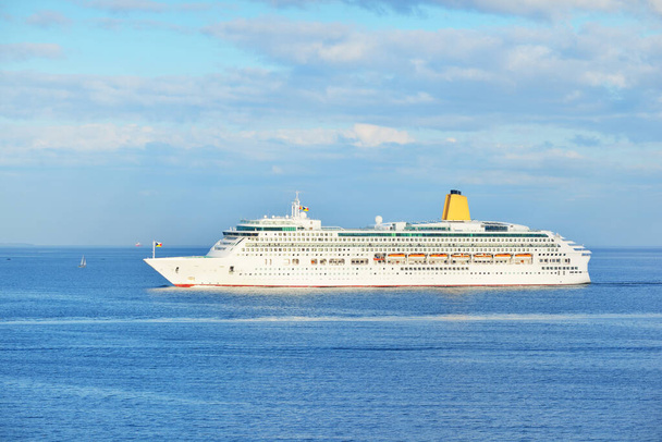 Passenger ship (cruise liner) sailing in an open sea on a clear day. Panoramic aerial view. Mediterranean sea, Spain. Travel destinations, summer vacations, recreation concepts - Photo, Image