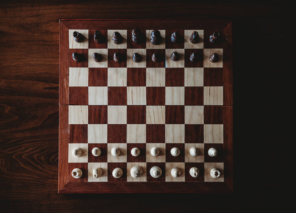 chess board with wooden chessboard, top view - Fotoğraf, Görsel
