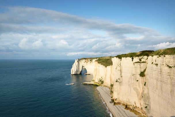 Picturesque panoramic aerial view of the Etretat white cliffs at sunset. Dramatic sky, azure water. Summer vacations in Normandy, France. Travel destinations, national landmark, sightseeing, history - Photo, Image